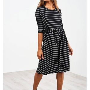 This is the latched mama 3/4 sleeve French terry nursing dress in black & white